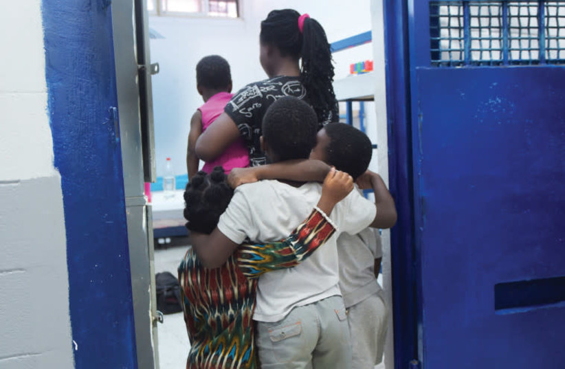 A Nigerian woman and her children in Givon prison (photo credit: AVSHALOM SASSONI/ MAARIV)