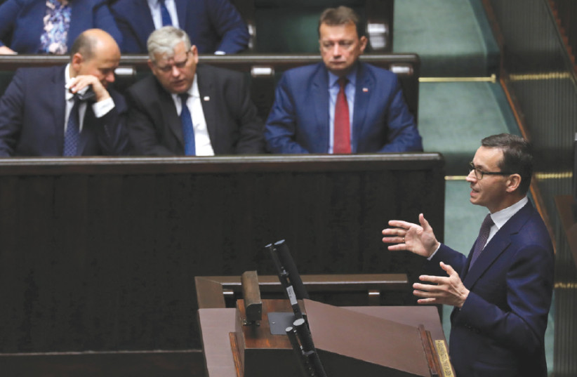 Poland’s Prime Minister Mateusz Morawiecki speaks during the debate about the Holocaust legislation in the lower house of Parliament in Warsaw on June 27, 2018 (photo credit: AGENCJA GAZETA VIA REUTERS)