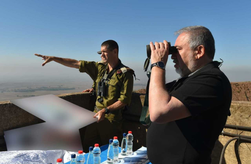 Defense Minister Avigdor Liberman looks at Syria from the Golan Heights (photo credit: ARIEL HERMONI / DEFENSE MINISTRY)
