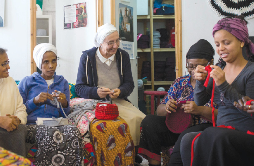 KUCHINATE, ‘CROCHETING’ in Tigrinya, the language of Eritrea, is a collective of African asylum-seeking women who crochet colorful baskets and carpets in a studio pulsing with children, hot food, volunteers and nuns (photo credit: MIRIAM ALSTER)