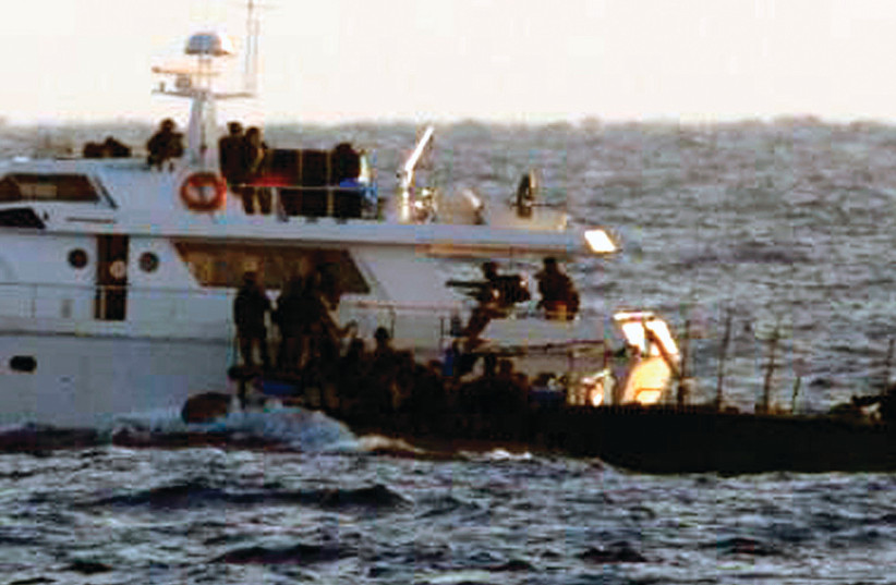 SOLDIERS BOARD one of the two Gaza-bound boats carrying pro-Palestinian activists in the Mediterranean Sea in 2011 (photo credit: REUTERS)