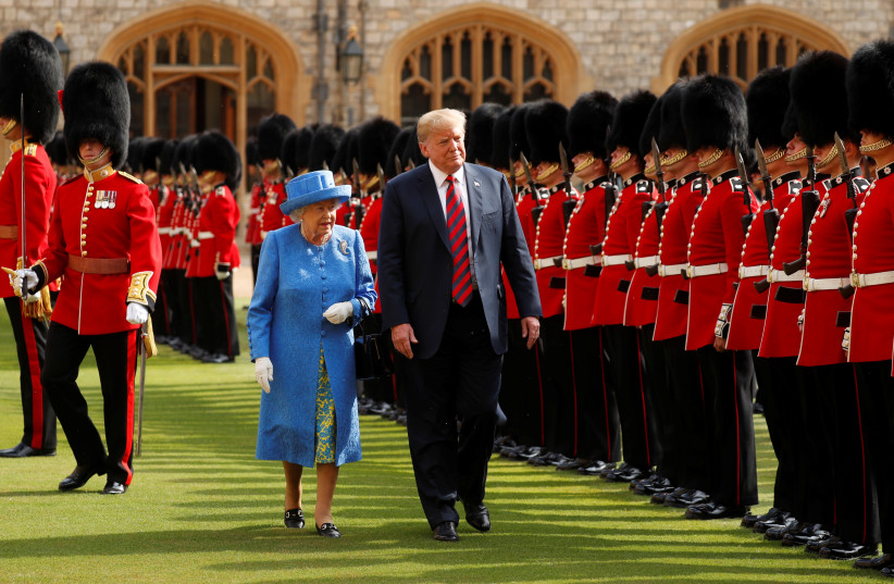 U.S. President Donald Trump and Britain's Queen Elizabeth inspect the Coldstream Guards during a visit to Windsor Castle (photo credit: KEVIN LAMARQUE/REUTERS)