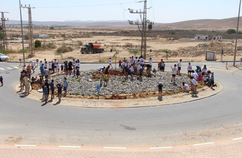 Youth from Perth and Merhav Am plant trees together on the new Merhav Am roundabout (photo credit: YOAV DEVIR KKL-JNF)