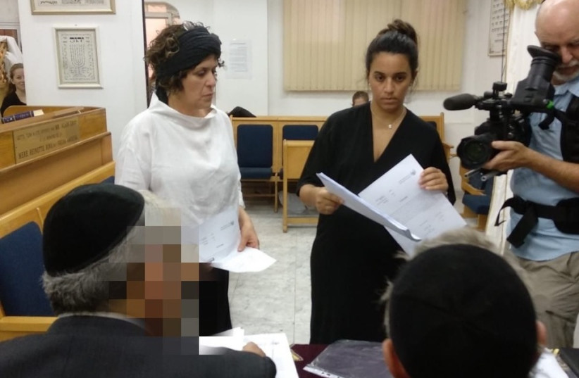 Oshrat Ben-Haim (center) stands before the rabbis of the independent rabbinical court alongside her rabbinical court representative and Mavoi Satum director Attorney Batya Kehana-Dror (photo credit: MAVOI SATUM)