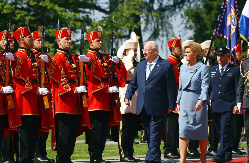 President Reuven Rivlin and Croatia's President Kolinda Grabsr-Kitarović review the honour guard in Zagreb, Croatia July 24, 2018 (photo credit: ANTONIO BRONIC/ REUTERS)