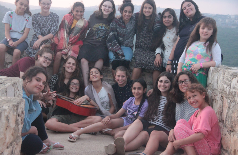 A group of campers spending time at the lookout in Yechiam, July 26, 2018. (photo credit: TALIA TZOUR AVNER)