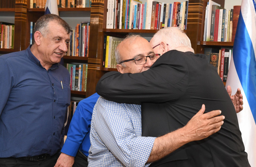 President Reuven Rivlin hugs heads of Druze local Councils at the President's Residence on Sunday, July 29 (photo credit: MARC NEYMAN/GPO)