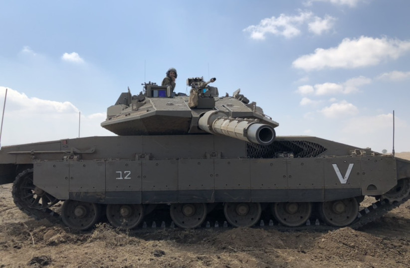 A soldier sits atop an IDF Merkava tank during a drill in Israel's north (credit: ANNA AHRONHEIM)