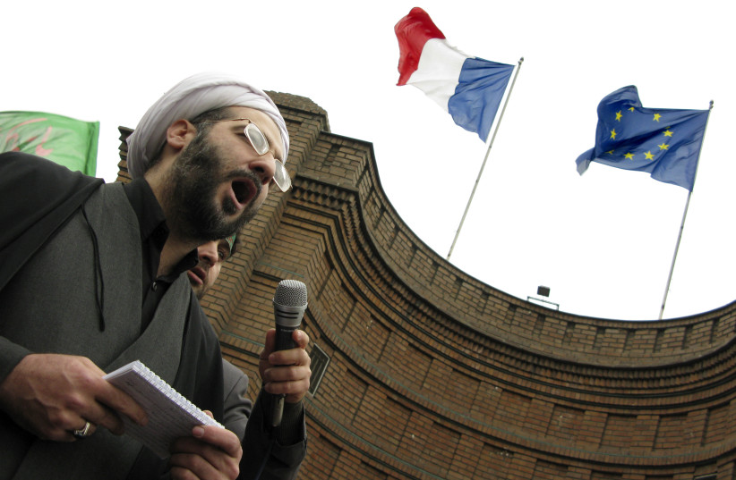 A cleric speaks in front of the French embassy in Tehran during a protest  (photo credit: REUTERS/MORTEZA NIKOUBAZL)