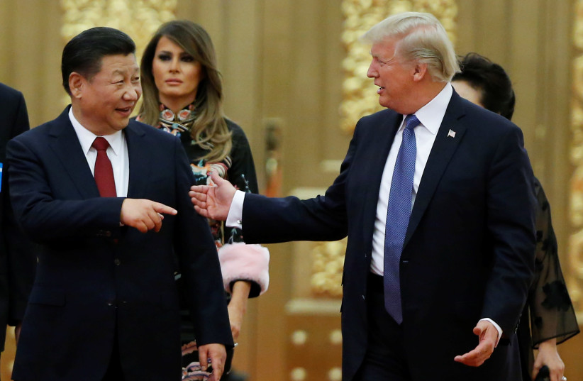 US President Donald Trump and China's President Xi Jinping arrive at state dinner, Great Hall of the People, Beijing, 2017. (photo credit: THOMAS PETER/REUTERS)