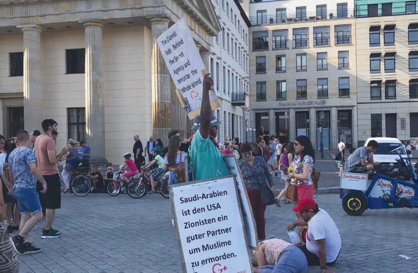 ‘THE FINAL outrage came from the man at the Brandenburg Gate who held a sign comparing Israelis to the Nazis and alleging a world Zionist conspiracy.’ (photo credit: MICAH THAU)