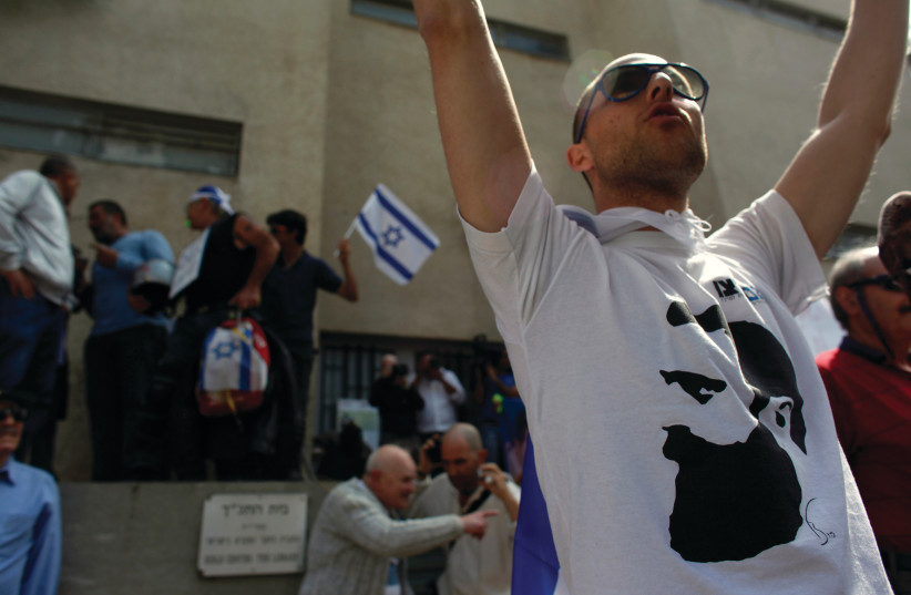 A PROTESTER wears a shirt with Theodor Herzl on it at a rally in Tel Aviv (photo credit: REUTERS)