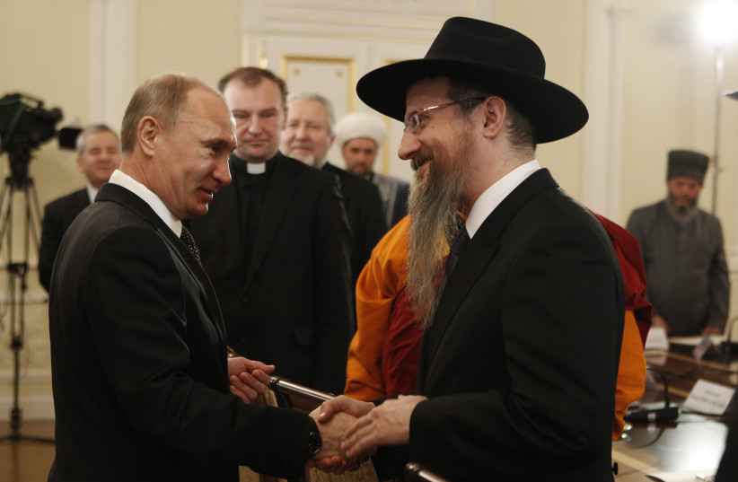 Russian Prime Minister Vladimir Putin shakes hands with Russia's Chief Rabbi Berel Lazar during his meeting with religious leaders in the Danilov Monastery in Moscow (February 8, 2012).  (photo credit: REUTERS/GRIGORY DUKOR)