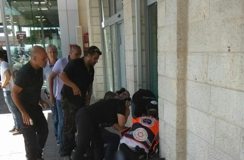 Paramedics attempt to save terrorist victim near Gush Etzion, September 16, 2018 (photo credit: MAGEN DAVID ADOM)