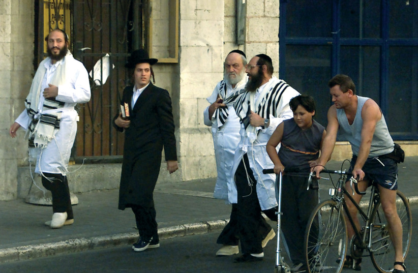 Bike-riders and synagogue-goers. ‘I don’t really miss doing the full ultra-Orthodox Yom Kippur because I don’t really feel the need to check off all the boxes or anything. For me it’s more important to just commemorate the day and have the feel of Yom Kippur,’ says Dovid.  (photo credit: REUTERS)