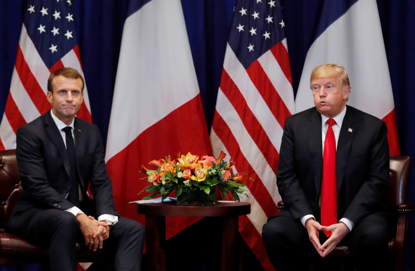 France's President Emmanuel Macron and US President Donald Trump react as they hold a bilateral meeting on the sidelines of the 73rd United Nations General Assembly in New York, September 24, 2018 (photo credit: CARLOS BARRIA / REUTERS)