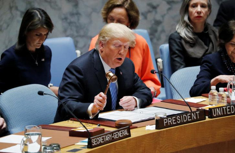 US President Donald Trump, representing the United States as current President of the United Nations Security Council, bangs the gavel to open the UN Security Council meeting at the 73rd session of the United Nations General Assembly at UN headquarters in New York (photo credit: CARLOS BARRIA / REUTERS)