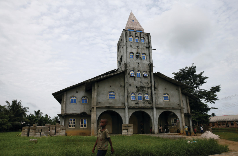 A BOY walk past the Apostolic church in Bodo, Nigeria (credit: REUTERS)