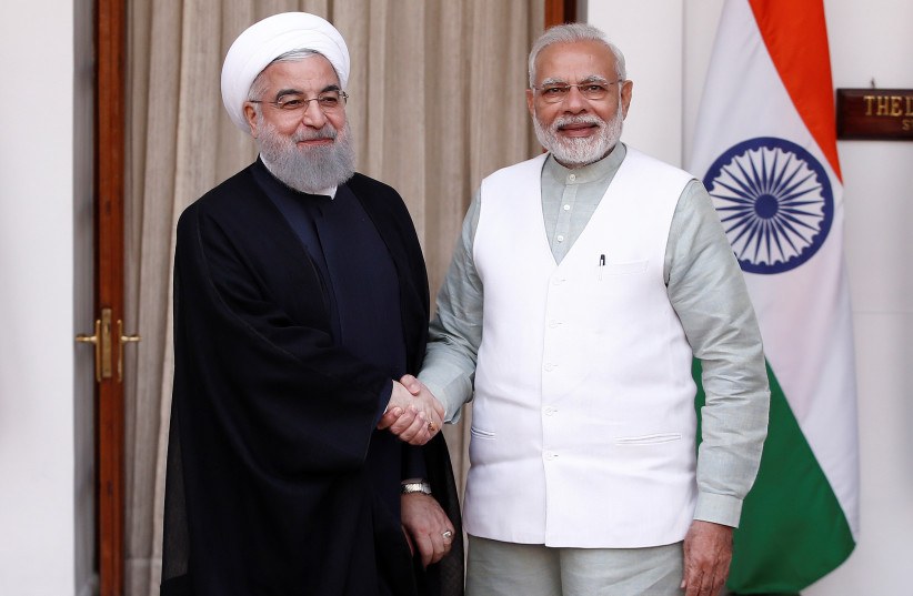 Iranian President Hassan Rouhani shakes hands with India's Prime Minister Narendra Modi (R) (photo credit: ADNAN ABIDI/ REUTERS)
