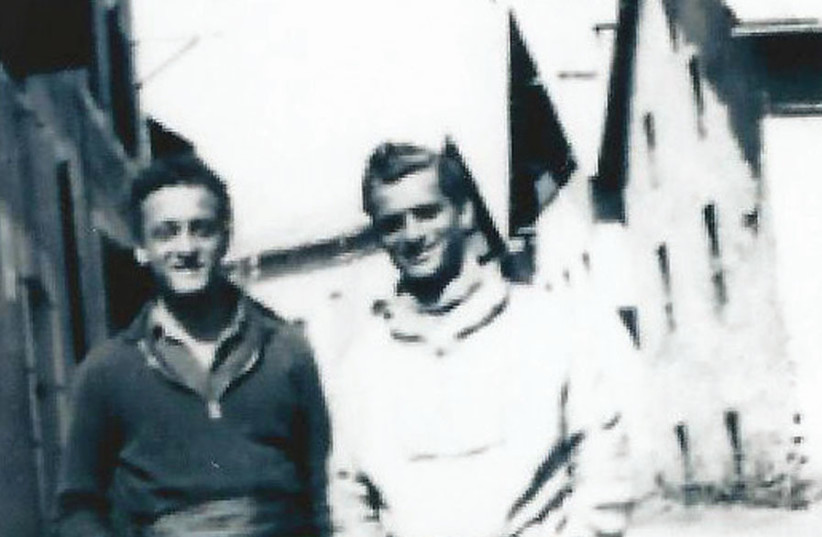 Jacques Graubart (right) in 1941 with a comrade from the French underground outside the hotel where Graubart worked, while ferrying families across the border to Switzerland (photo credit: Courtesy)