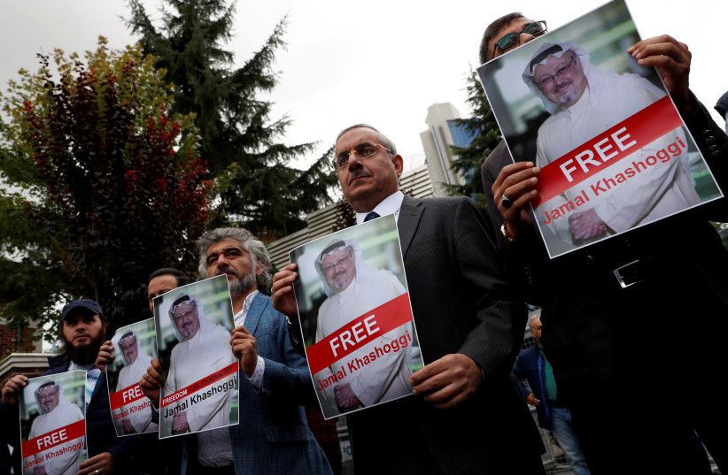 Human rights activists and friends of Saudi journalist Jamal Khashoggi hold his pictures during a protest outside the Saudi Consulate in Istanbul, Turkey October 8, 2018 (photo credit: REUTERS/MURAD SEZER/FILE PHOTO)
