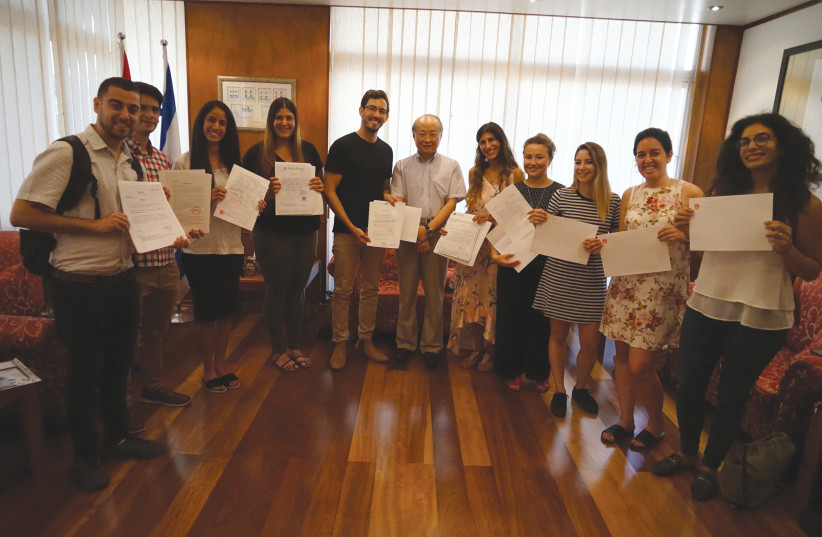AMBASSADOR ZHAN YONGXIN awards scholarship certificates from the Chinese government to the winning Israeli students in August. (Chinese Embassy)  17 Technion’s campus in China I  n December 2015, the Guang- dong Technion-Israel Institute  of Technology was inaugurated. GTIIT aims to become a top-lev (photo credit: CHINESE EMBASSY)