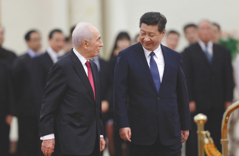 PRESIDENT SHIMON Peres chats with China’s President Xi Jinping at the Great Hall of the People in Beijing April 2014 (photo credit: REUTERS)
