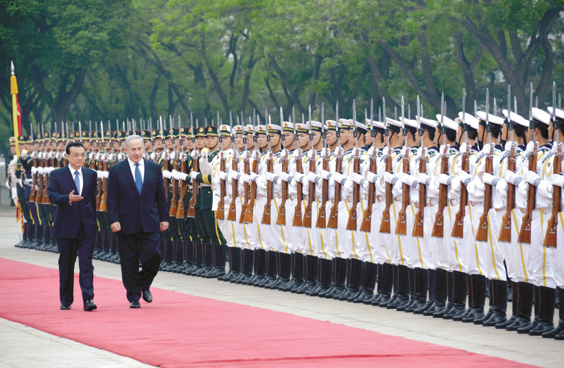 CHINESE PREMIER Li Keqiang escorts Prime Minister Benjamin Netanyahu past an honor guard outside the Great Hall of the People in Beijing (photo credit: GPO)