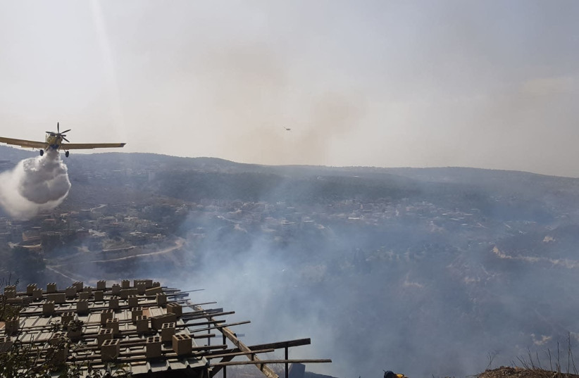A firefighting plane works to extinguish a fire in Umm al-Fahm, October 22, 2018  (photo credit: ISRAEL POLICE)