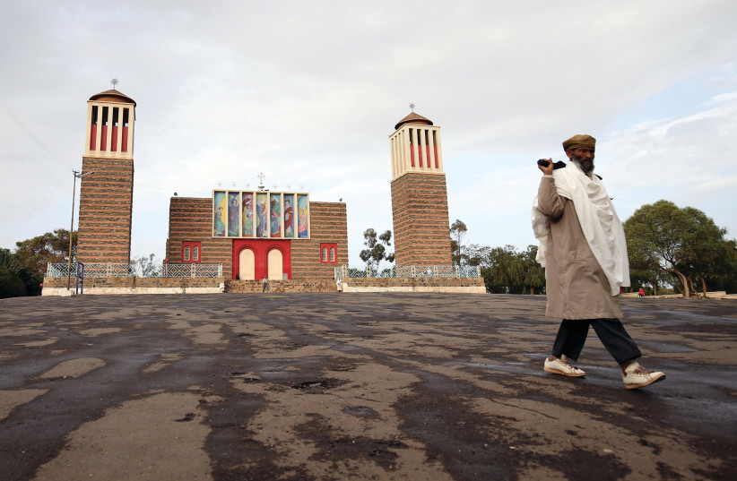 A man walks in front of a church in Eritrea (photo credit: REUTERS)