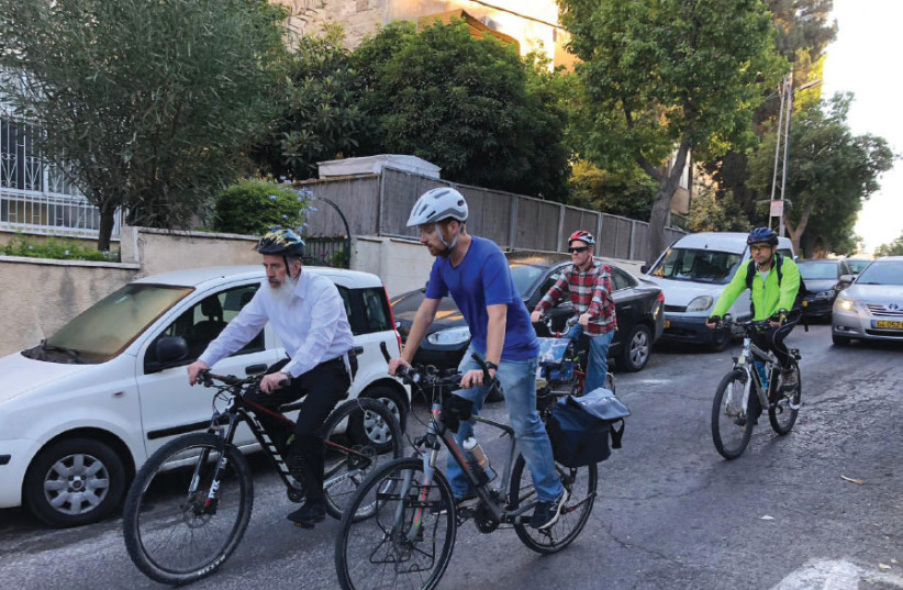 Mayoral candidate Yossi Daitch (left) cycles. (photo credit: Courtesy)