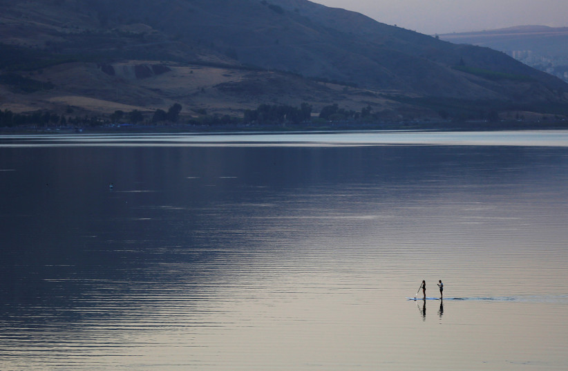PEOPLE ON paddle boards float on Lake Kinneret in 2016. It is Israel’s major surface fresh-water source, now endangered. (photo credit: REUTERS/Ronen Zvulun)