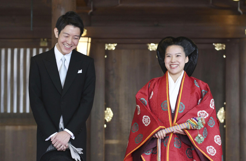 Japanese Princess Ayako (R) and her husband Kei Moriya answer reporters' questions after their wedding ceremony at the Meiji Shrine in Tokyo, Japan (photo credit: KYODO/VIA REUTERS)