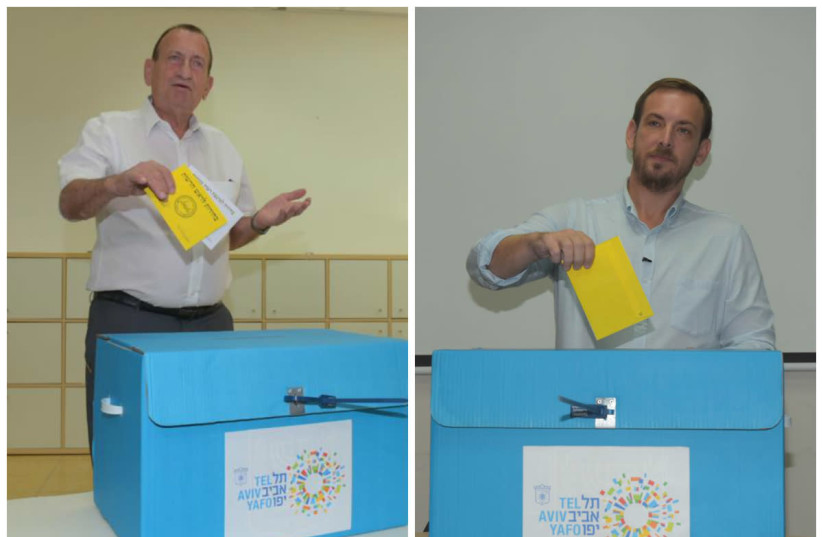 Tel Aviv mayoral candidates Ron Huldai (L) and Asaf Zamir (R) cast their votes in the city's municipal elections, October 30, 2018 (photo credit: AVSHALOM SASSONI/ MAARIV)