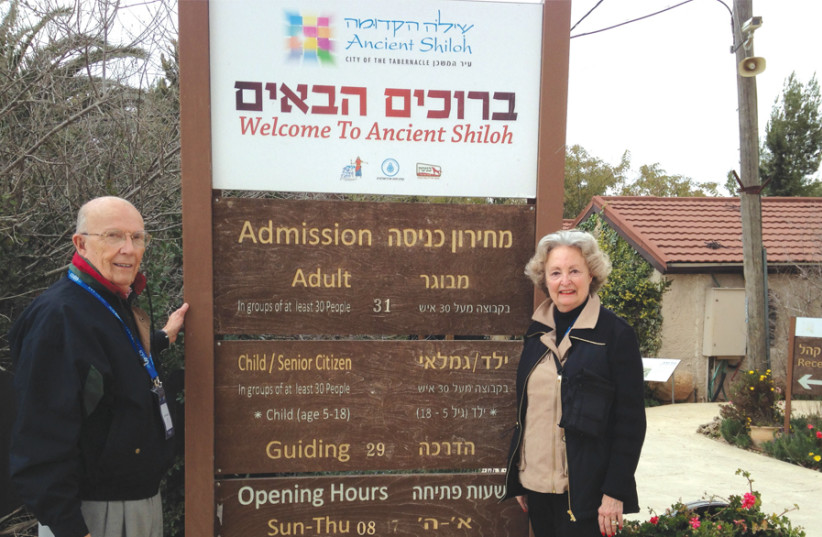 Sally Howard, seen here with her husband, John, at the entrance to Shiloh, says their choice to invest in Israel is biblically motivated (photo credit: Courtesy)
