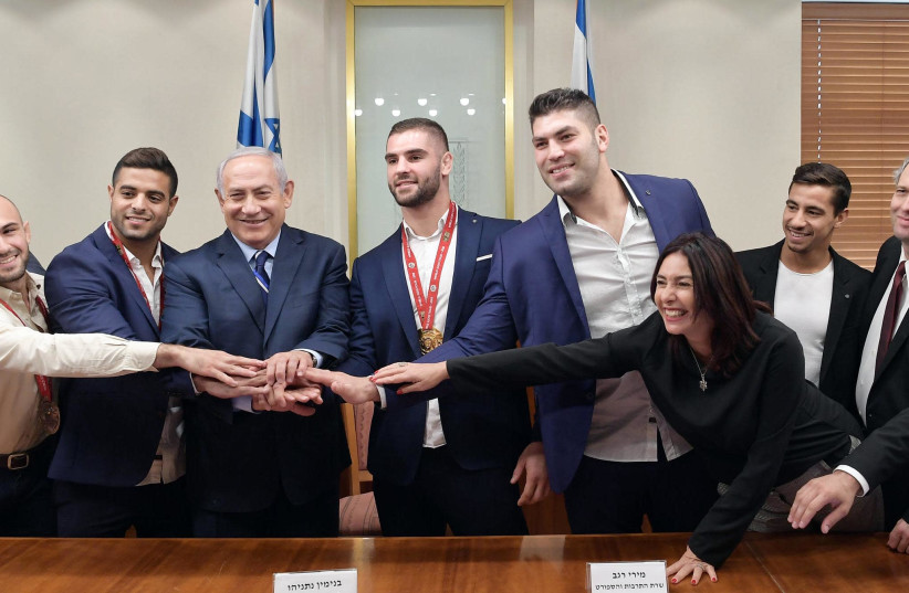 Israeli Judokas meet with Prime Minister Benjamin Netanyahu and Culture and Sports Minister Miri Regev at the Prime Minister's office on Thursday, November 8, 2018 (photo credit: GPO/AMOS BEN GERSHOM)