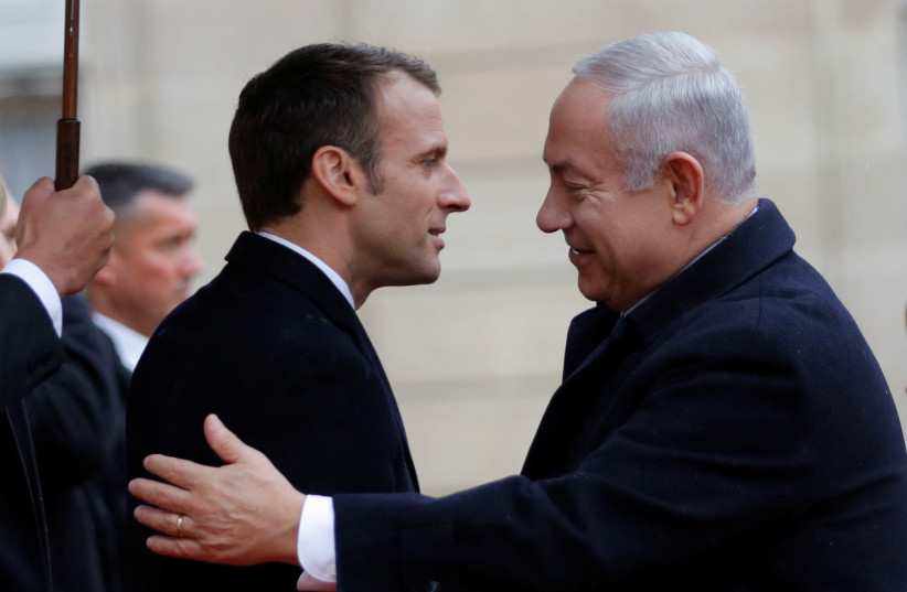 French President Emmanuel Macron welcomes Israel Prime Minister Benjamin Netanyahu at the Elysee Palace as part of the commemoration ceremony for Armistice Day, 100 years after the end of the First World War, in Paris, France, November 11, 2018. (photo credit: PHILIPPE WOJAZER/REUTERS)