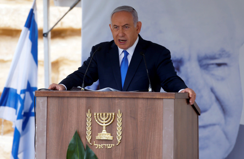 Israeli Prime Minister Benjamin Netanyahu speaks during an annual state memorial ceremony for Israel's first prime minister, David Ben Gurion, at his gravesite in Sde Boker Israel November 14, 2018 (photo credit: RONEN ZVULUN/REUTERS)