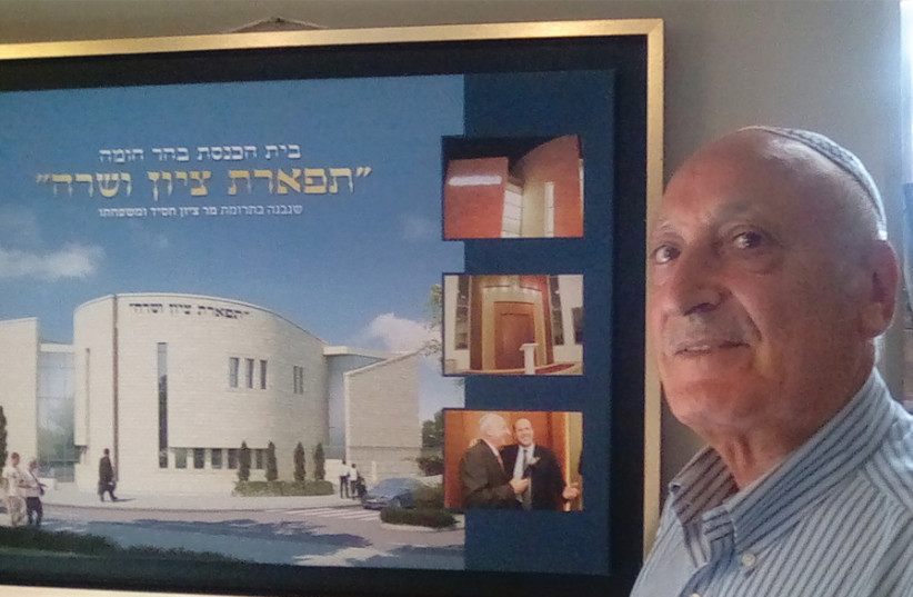 Zion Hasid, head of the Central Organization of Iranian Immigrants in Israel, with a poster of the Tiferet Zion V’Sara synagogue he built in Jerusalem. (photo credit: HAGAY HACOHEN)