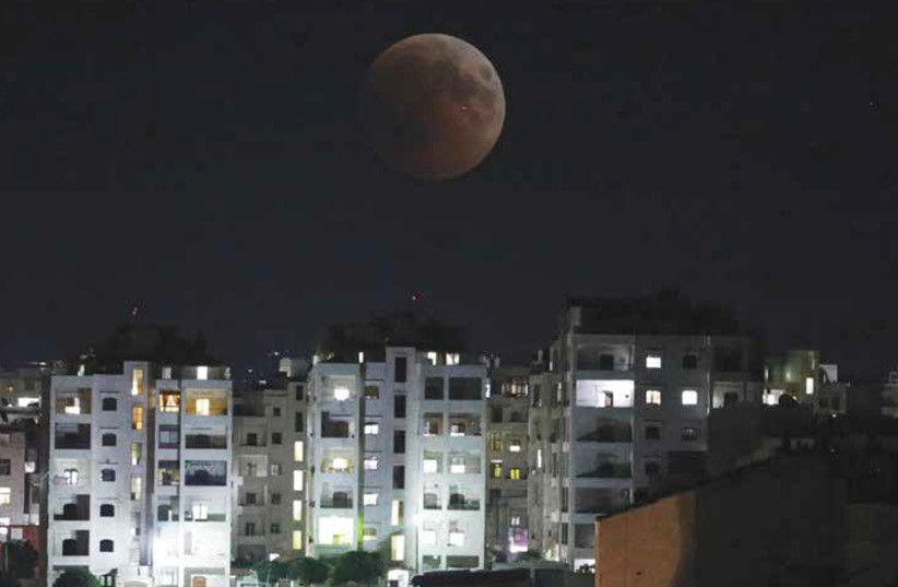 THE MOON is seen during a lunar eclipse over Idlib, Syria, on July 27. (photo credit: REUTERS)