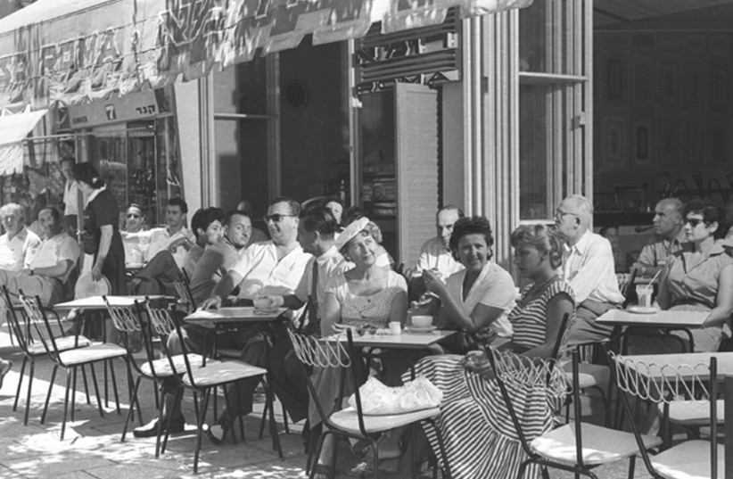 DAY AND night in two Tel Aviv cafés: Enjoying refreshment on Ben-Yehuda Street, 1957 (left) and Atarim Square, 1980. (photo credit: FRITZ COHEN)