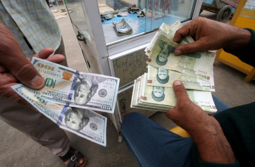 Iranian rials, U.S. dollars and Iraqi dinars at a currency exchange shop in Basra, Iraq, November 3, 2018. Picture taken November 3, 2018. (photo credit: REUTERS/ESSAM AL-SUDANI)