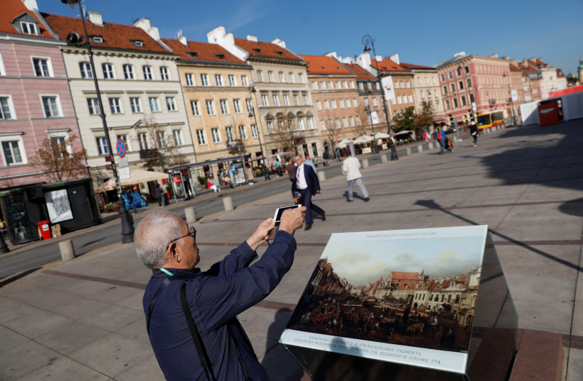 A tourist takes a picture at the Old Town in Warsaw, Poland September 17, 2018. (photo credit: KACPER PEMPEL / REUTERS)