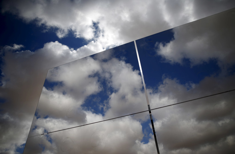 Heliostat mirrors reflect the sky in a field at the construction site of a 240 meter (787 feet) solar-power tower in Israel's southern Negev Desert, February 8, 2016. The world's tallest solar-power tower is being built off a highway in the Negev Desert in southern Israel, its backers hoping the tec (photo credit: AMIR COHEN/REUTERS)