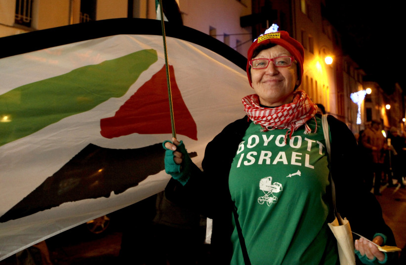A woman wearing a T-shirt which reads, "Boycott Israel", takes part in a demonstration in favour of the occupied Palestinian people of Gaza in Brussels December 27, 2011. (photo credit: REUTERS/SEBASTIAN SCHEINER/POOL)