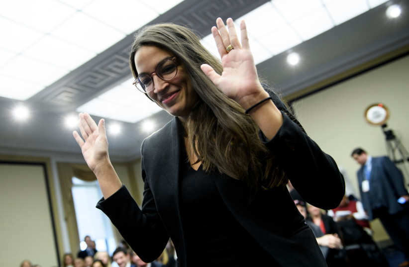 US Representative-elect Alexandria Ocasio-Cortez (D-NY) walks up to participate in drawing a lottery number for her new office on Capitol Hill November 30, 2018 in Washington, DC (photo credit: BRENDAN SMIALOWSKI / AFP)