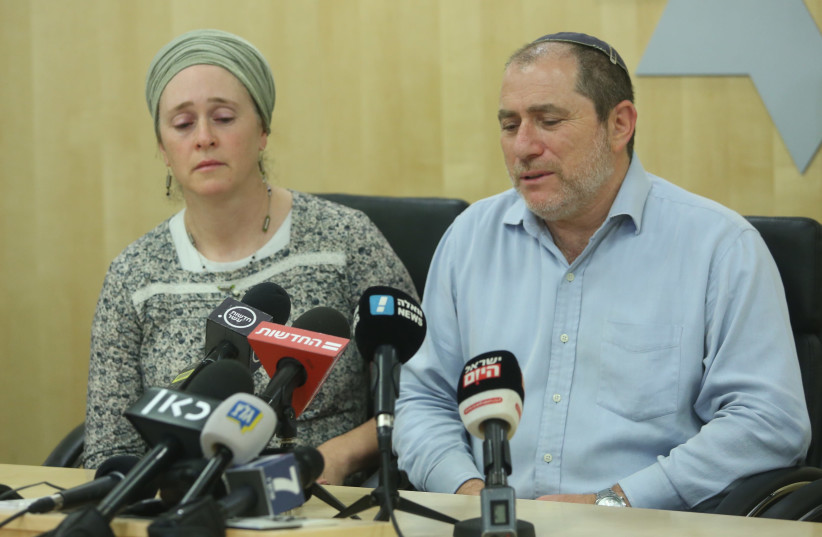 Terror victims parent's Liora and Chaim Silberstein update reporters on their daughter's condition. (photo credit: MARC ISRAEL SELLEM)