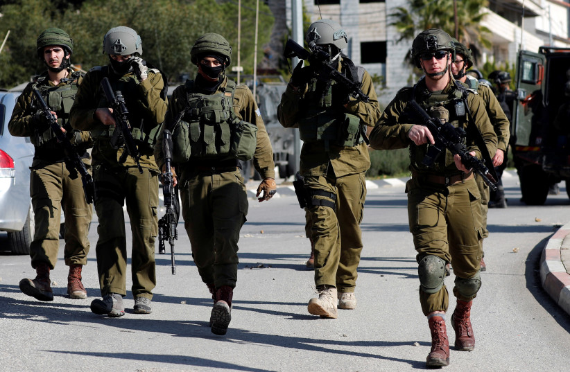 Israeli soldiers walk during clashes with Palestinians in Ramallah in the West Bank, 2018. (photo credit: REUTERS/MOHAMAD TOROKMAN)