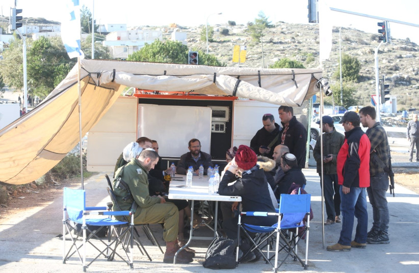 Settler leaders meeting at site of Givat Assaf shooting attack, December 13, 2018 (photo credit: MARC ISRAEL SELLEM/THE JERUSALEM POST)