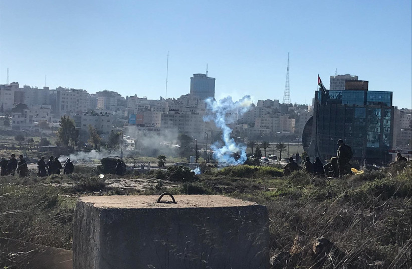 The IDF and Border Police used tear gas and a bulldozer during the clashes which comes in the wake of the drive by shooting attack that killed two soldiers yesterday (photo credit: SETH J. FRANTZMAN)